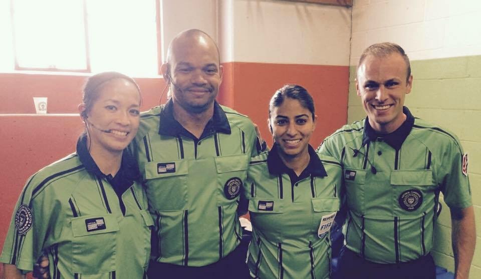 Deleana poses with her NWSL game crew during a 2015 match. Pictured L-R are: Deleana Quan (AR1), Chipalo Street, (4th Official, WA), Christina Unkel (Referee, FL), and Josh Haimes (AR2, WA). Photo Courtesy of Deleana Quan